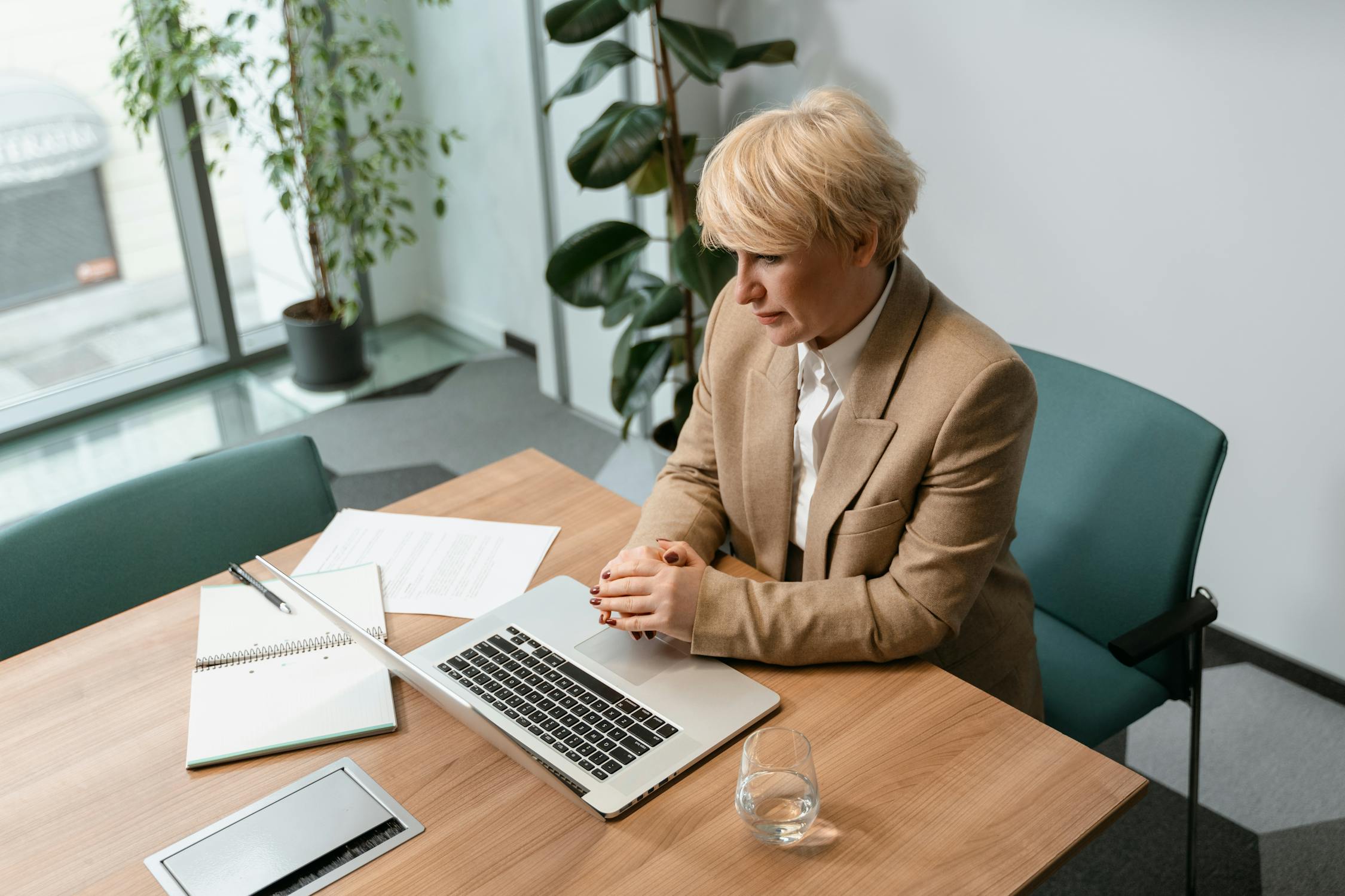 Professional reviewing her scheduling system on a computer