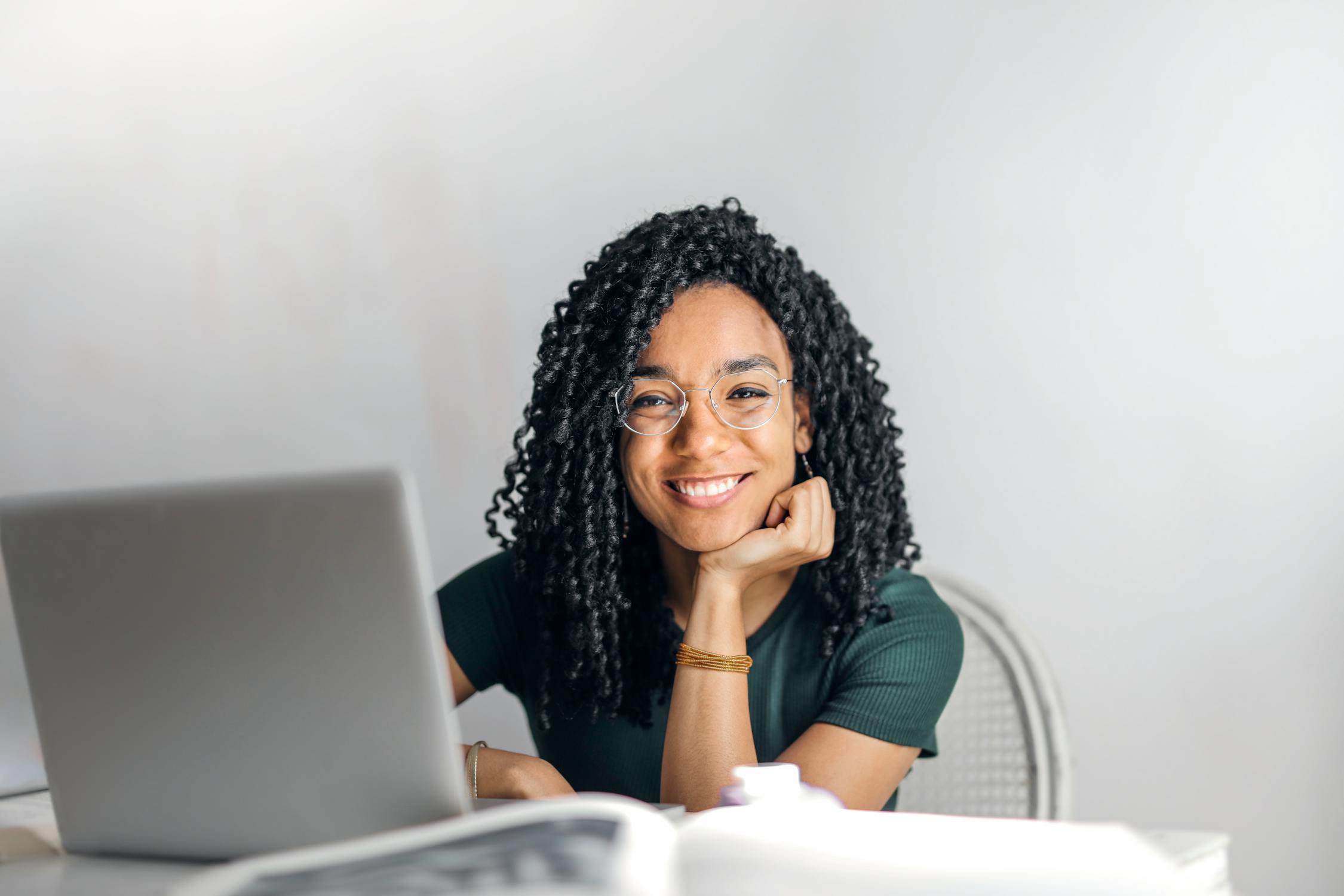 Happy business owner working at her laptop