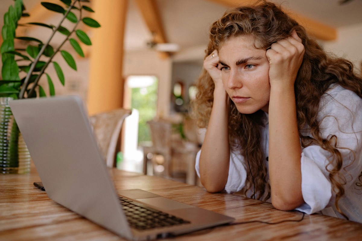 Frustrated woman staring at laptop screen